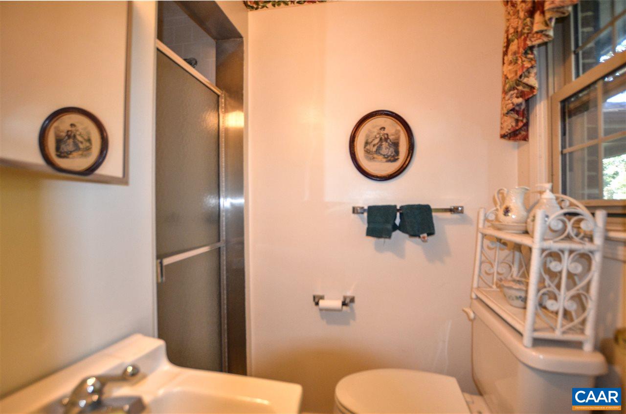 5770 Willow Spring Road Crozet, VA 22932 - Photo 37 of 49 a bathroom with a toilet and a shower curtain