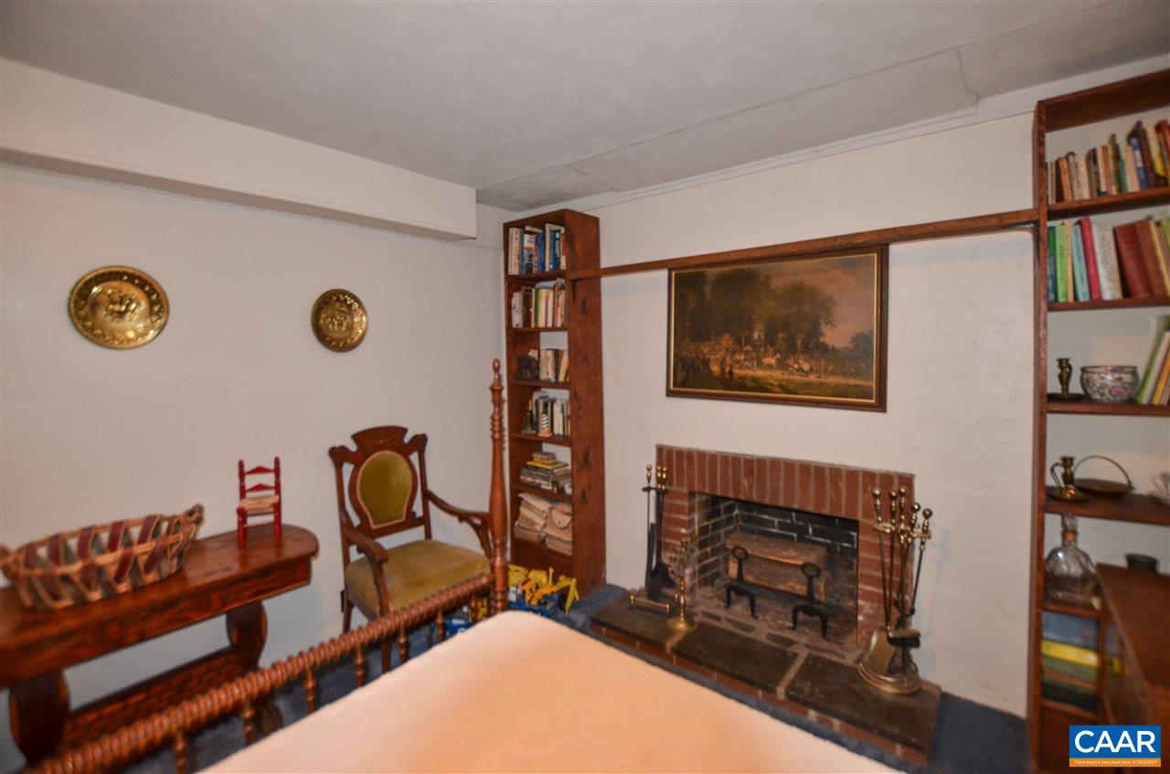 5770 Willow Spring Road Crozet, VA 22932 - Photo 42 of 49 a living room with furniture a flat screen tv and a fireplace
