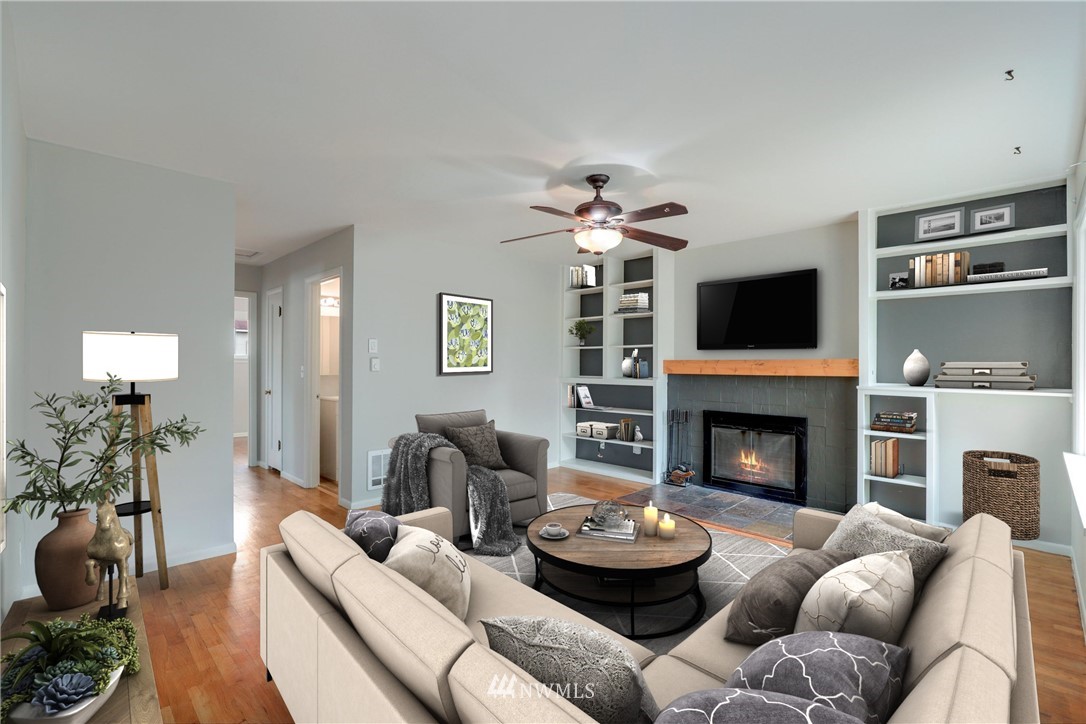 340 Wells Avenue North Renton, WA 98057 - Photo 3 of 23 a living room with furniture and a fireplace