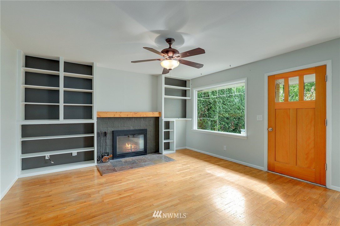 340 Wells Avenue North Renton, WA 98057 - Photo 4 of 23 a view of an empty room with a fireplace and a window