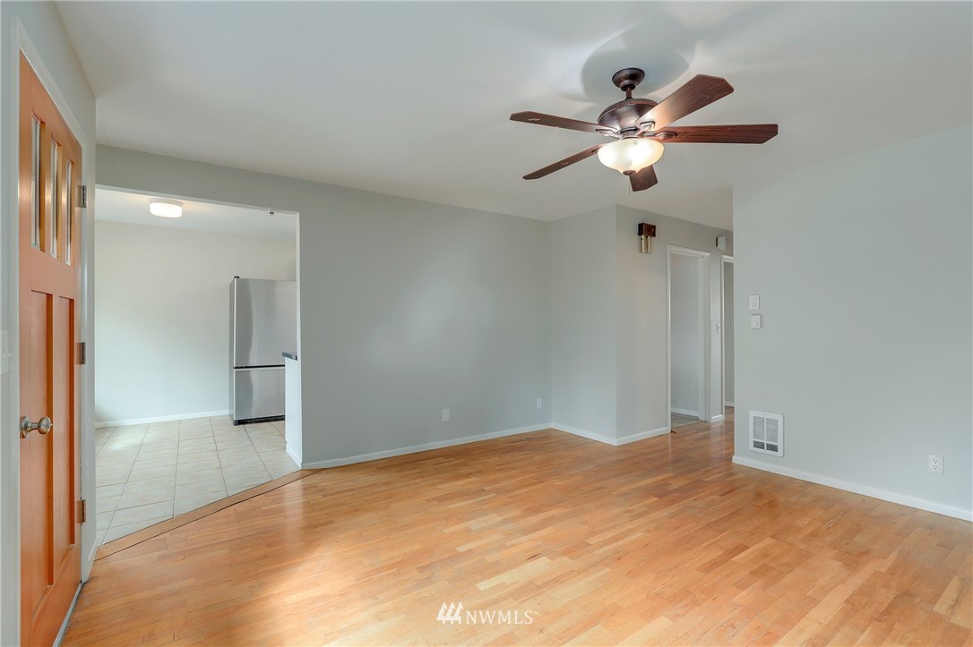340 Wells Avenue North Renton, WA 98057 - Photo 6 of 23 a view of empty room with wooden floor and ceiling fan