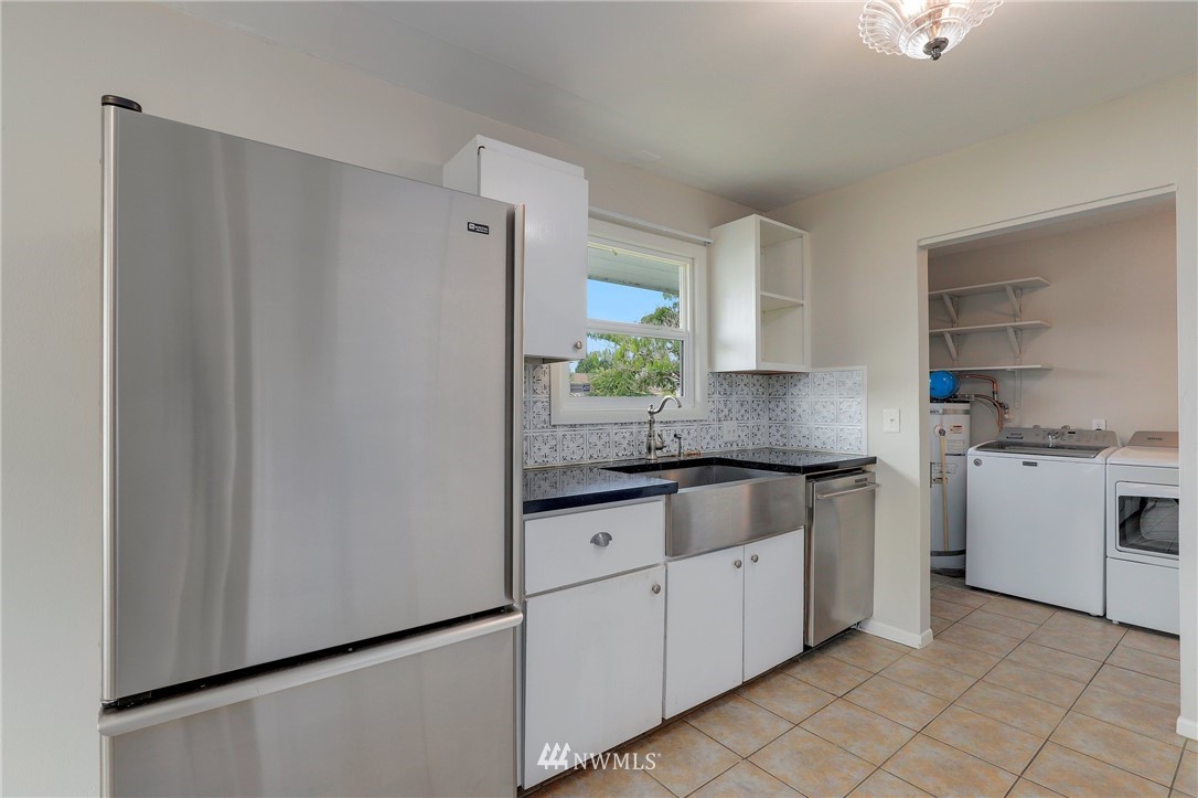 340 Wells Avenue North Renton, WA 98057 - Photo 9 of 23 a kitchen with granite countertop white cabinets and white appliances