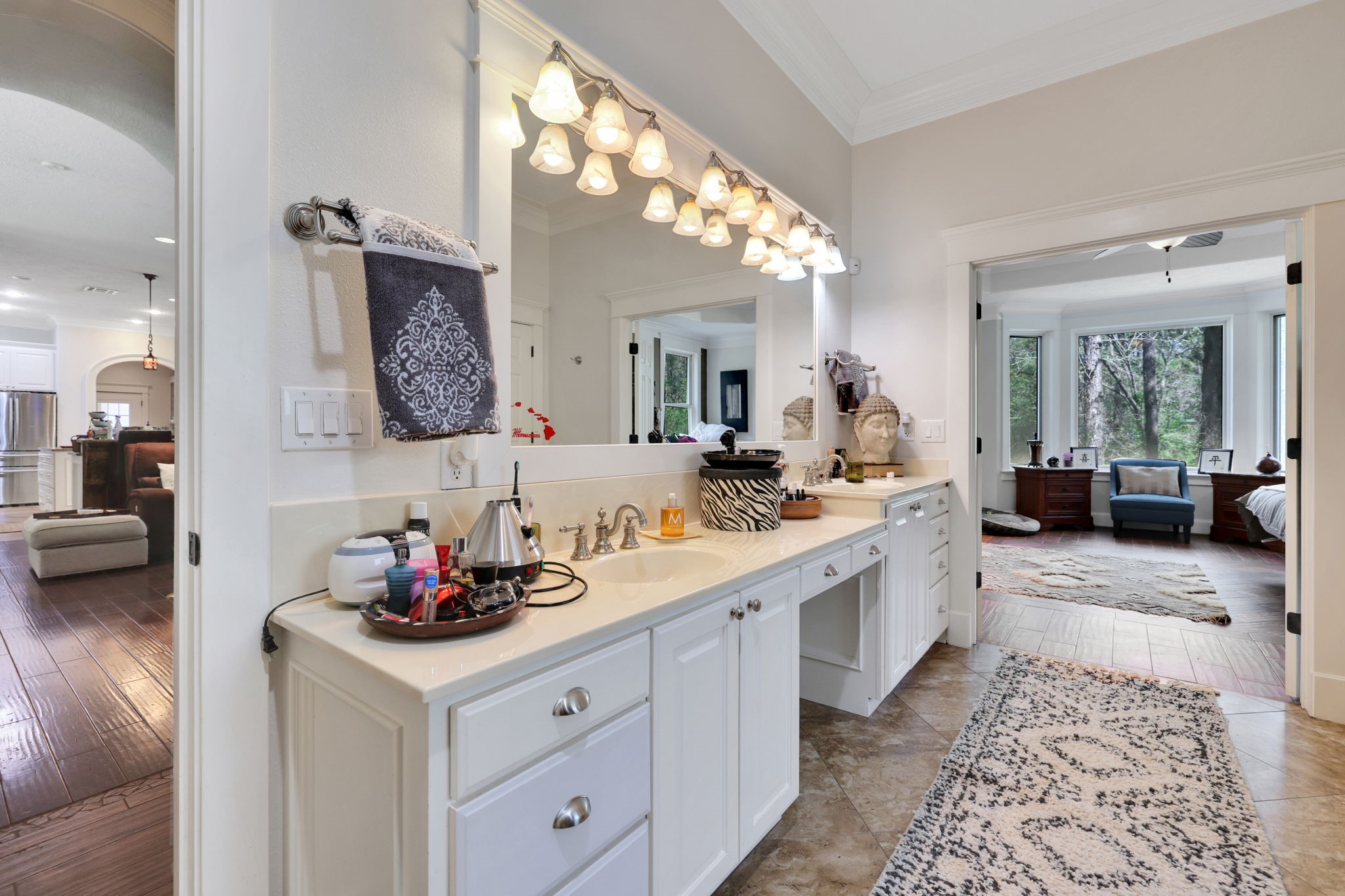 250 Critter Creek Road Coldspring, TX 77331 - Photo 14 of 48 a spacious bathroom with a double vanity sink and a mirror