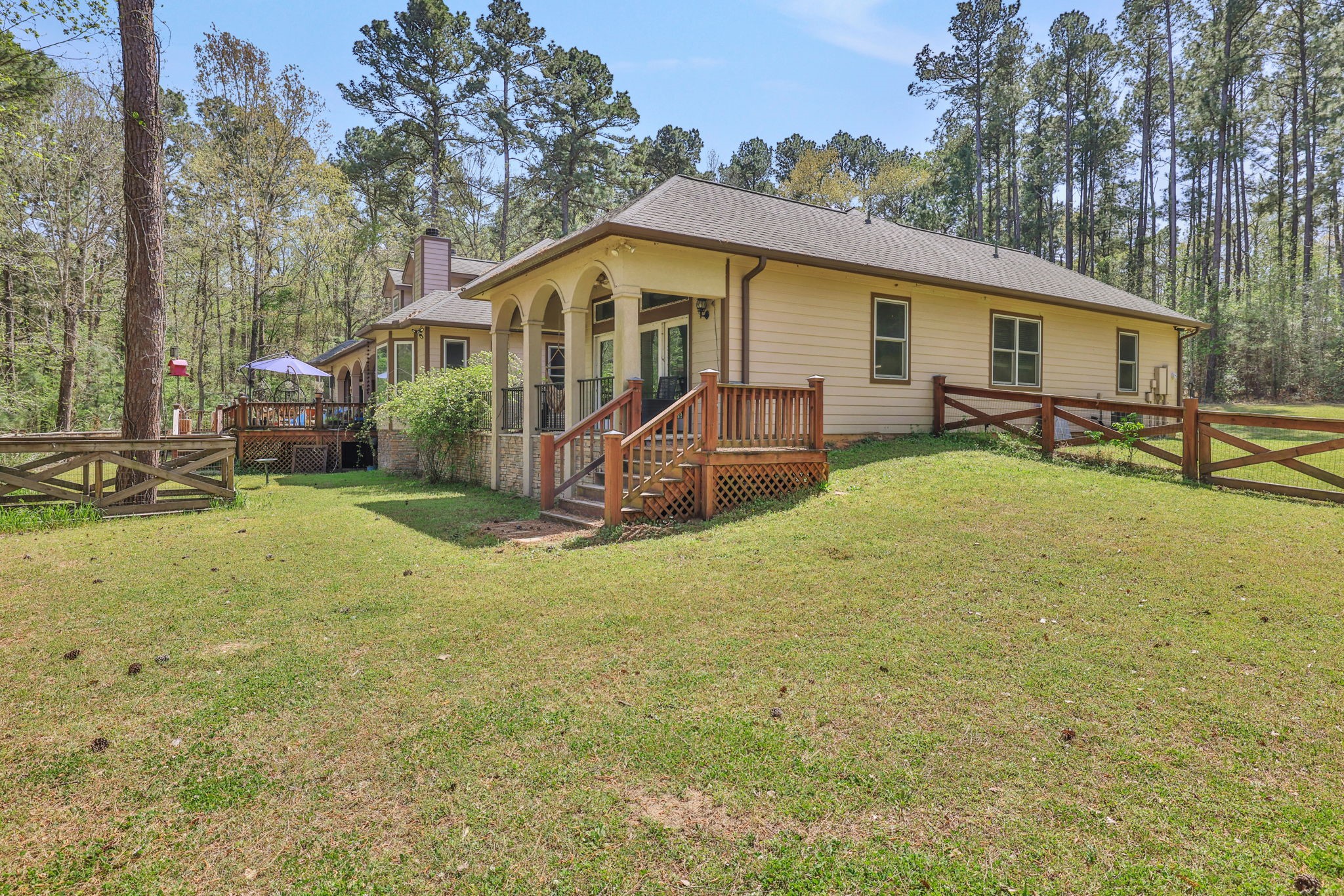 250 Critter Creek Road Coldspring, TX 77331 - Photo 19 of 48 a view of a house with backyard and sitting area