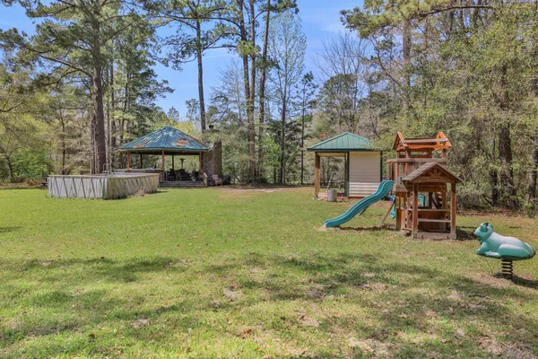 a view of a house with a yard and sitting area