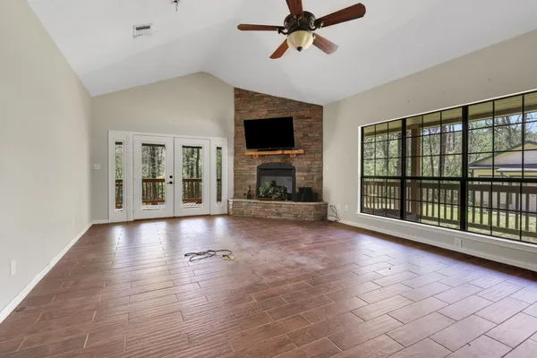 a view of empty room with wooden floor and fireplace
