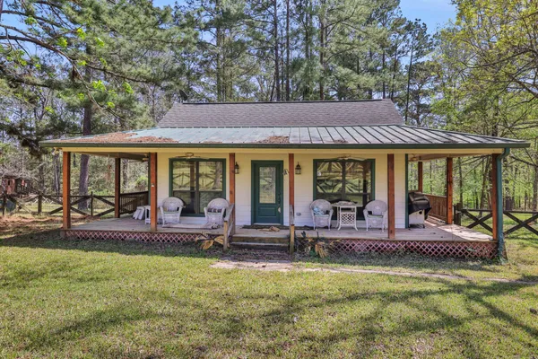 a view of house with outdoor seating area