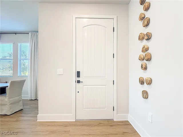 a view of a room with wooden floor and windows