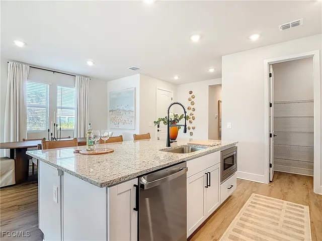 a kitchen with a sink stove and cabinets