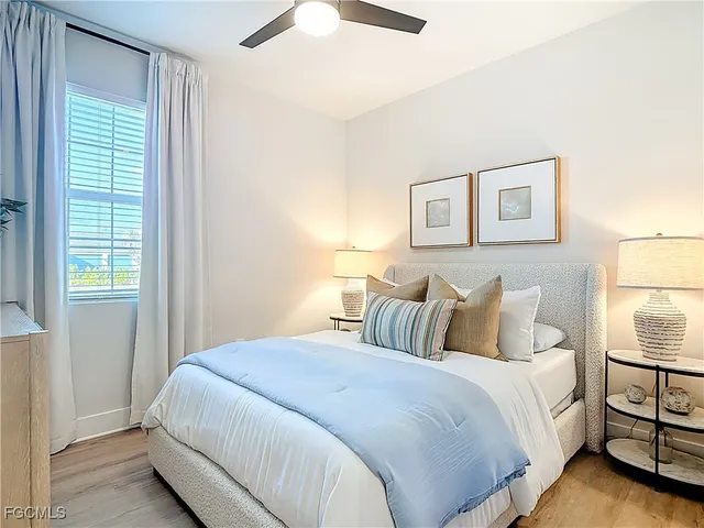 a bedroom with a bed and a night stand