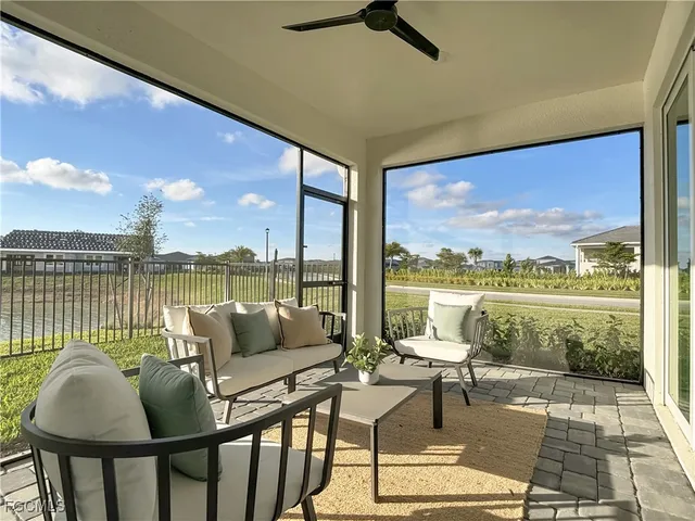 a living room with couches and coffee table with garden view