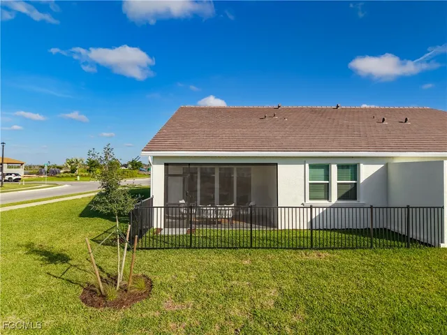 a view of a house with backyard and porch