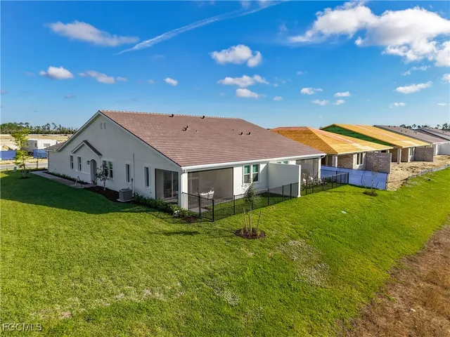 a view of a house with a big yard and large trees