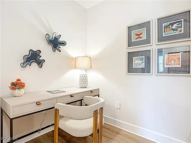 a kitchen with a table and a painting on the wall