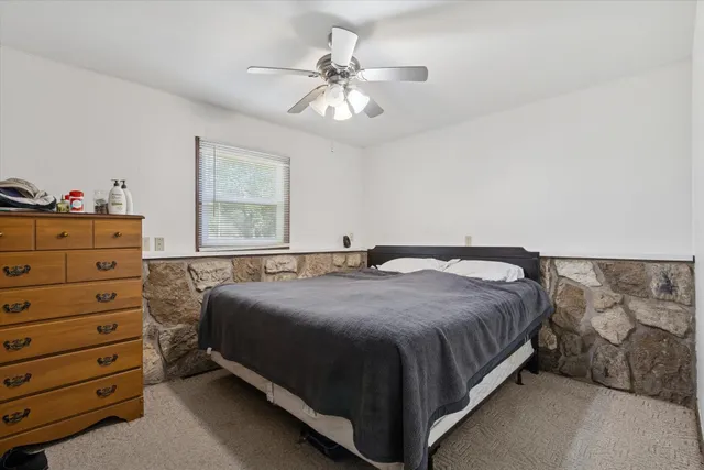 a bedroom with a bed and a dresser