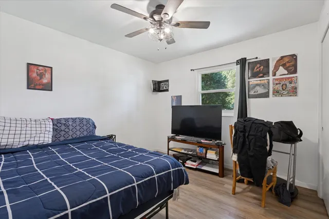 a bedroom with a bed and a flat screen tv