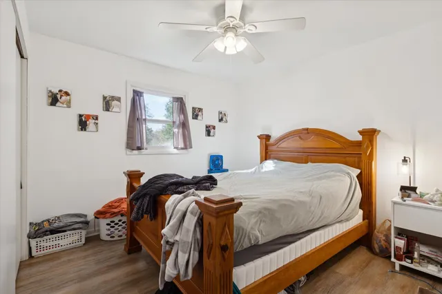 a bedroom with a bed and wooden floor