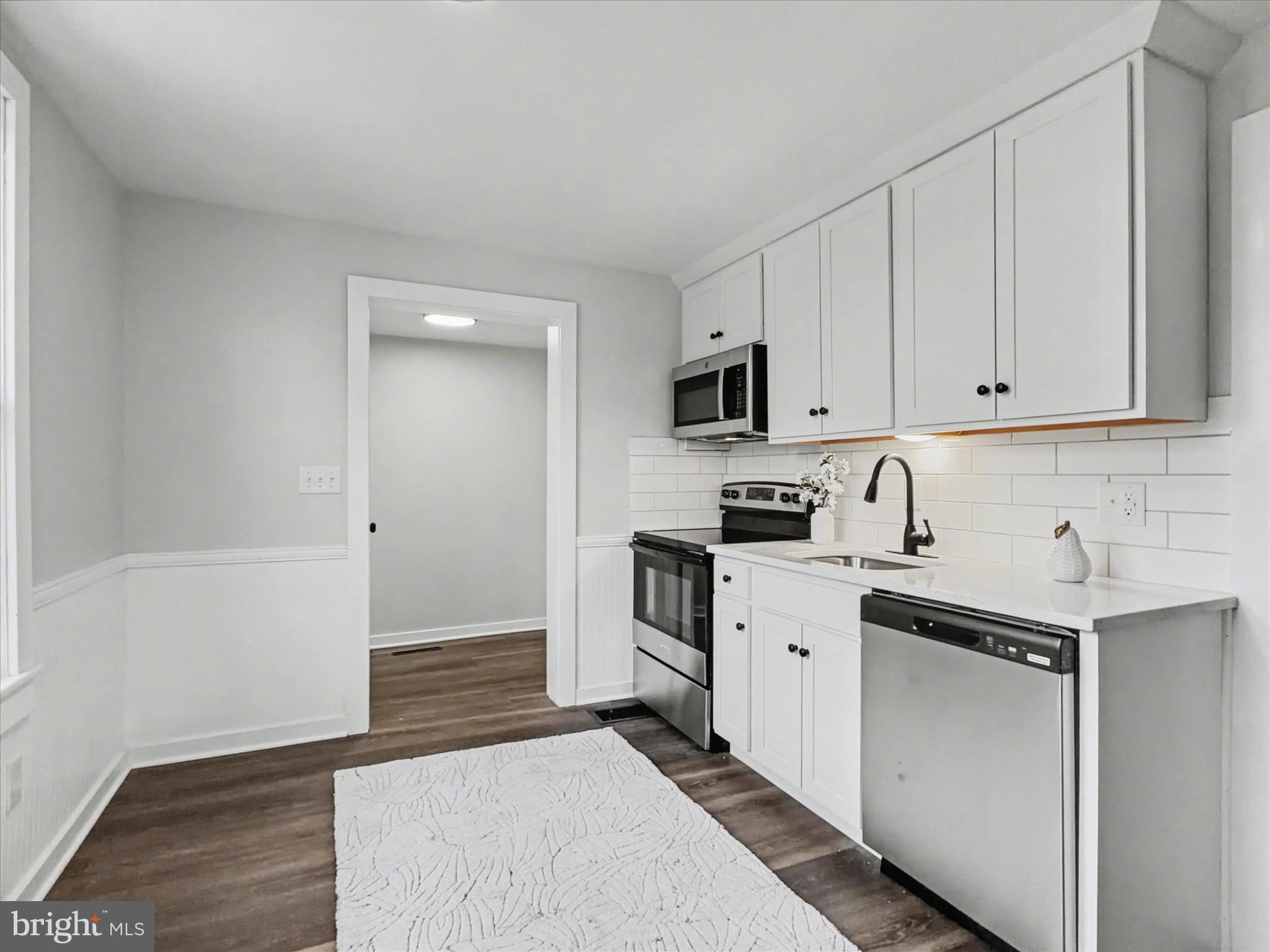 744 Forge Road Carlisle, PA 17015 - Photo 15 of 22 a kitchen with a sink stove and cabinets