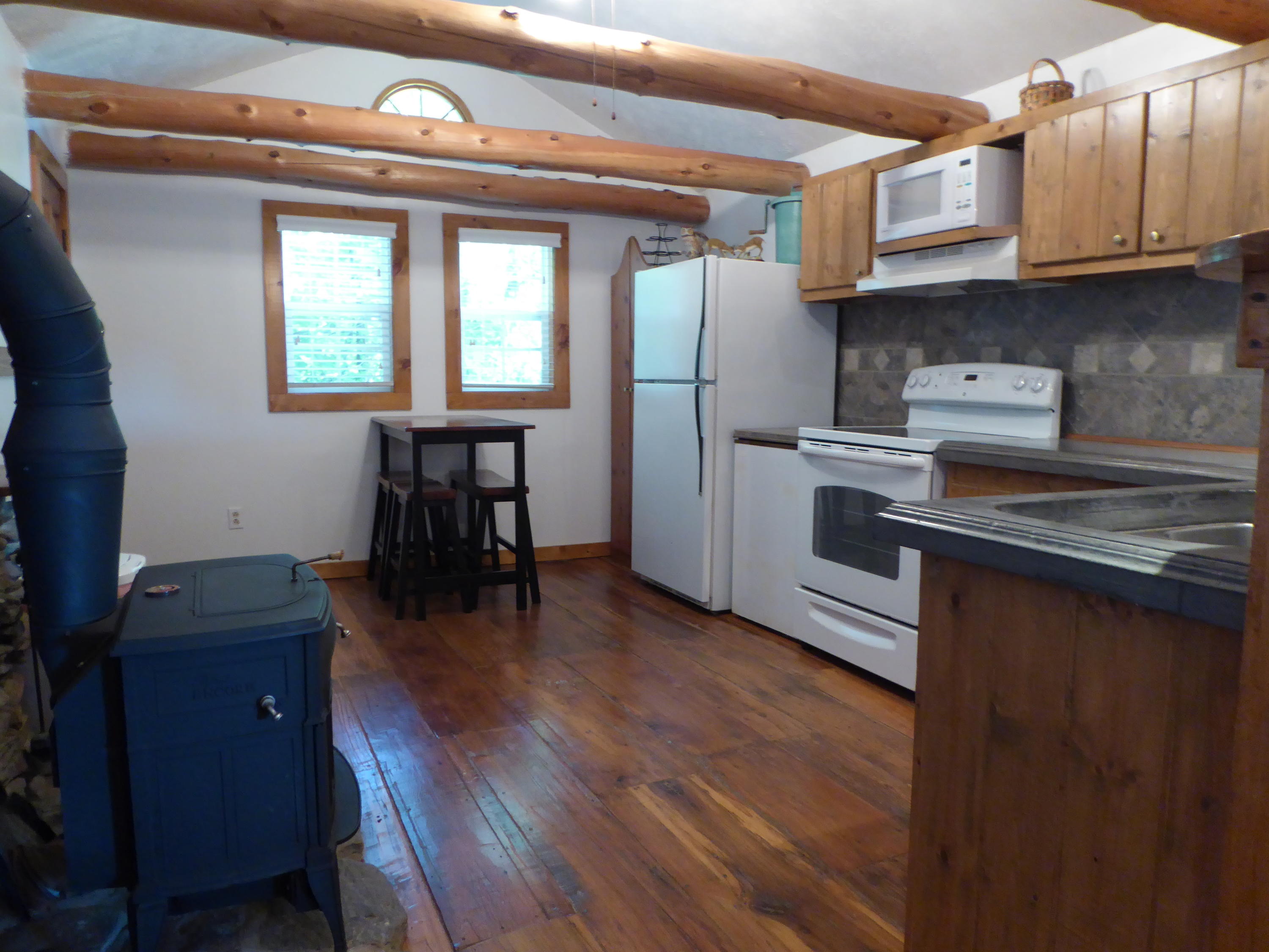 500 Hurds Branch Road Ferrum, VA 24088 - Photo 22 of 60 a kitchen with stainless steel appliances granite countertop a refrigerator a stove a sink and dishwasher with wooden floor