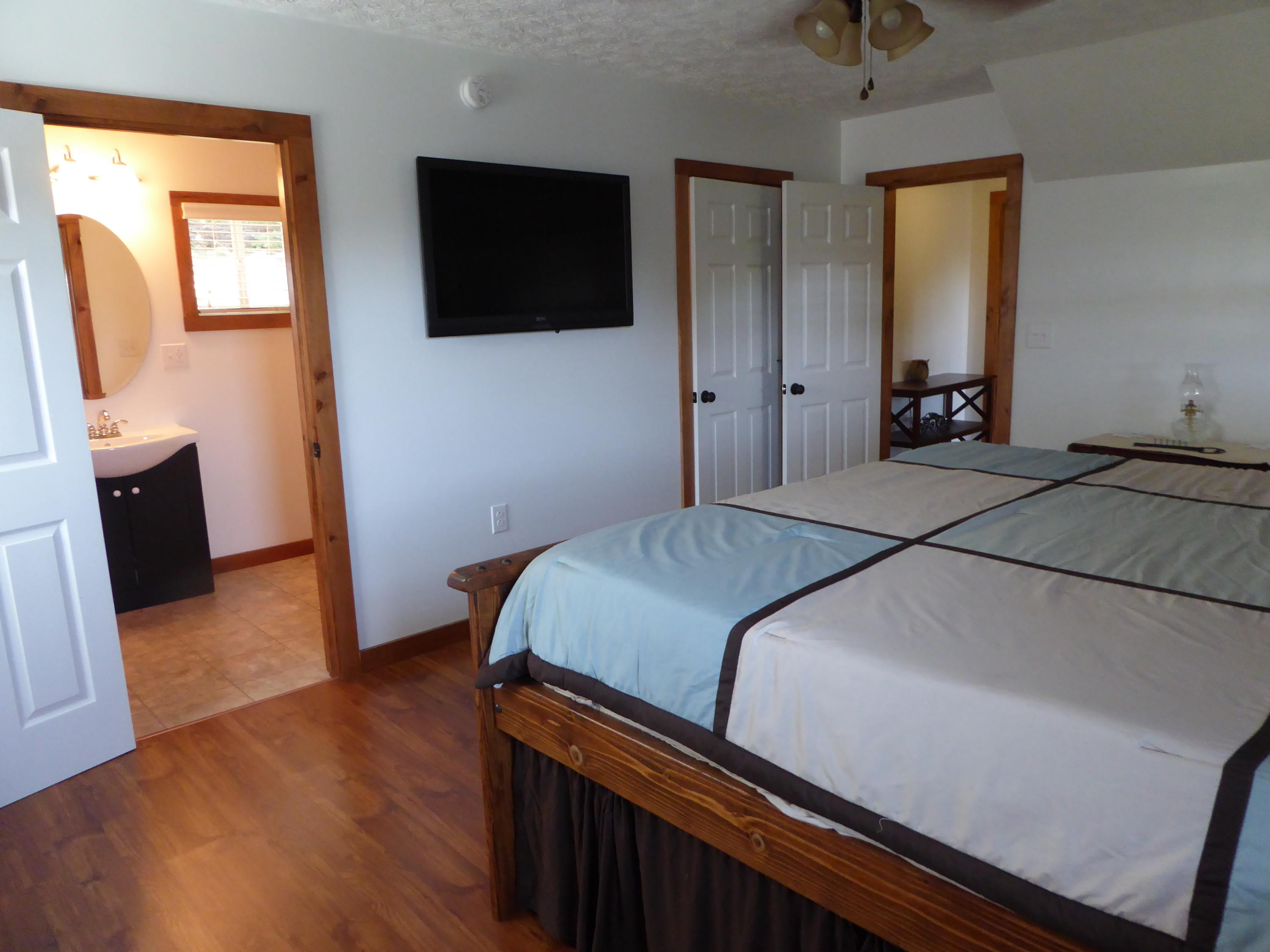 500 Hurds Branch Road Ferrum, VA 24088 - Photo 28 of 60 a bedroom with a bed and a flat screen tv