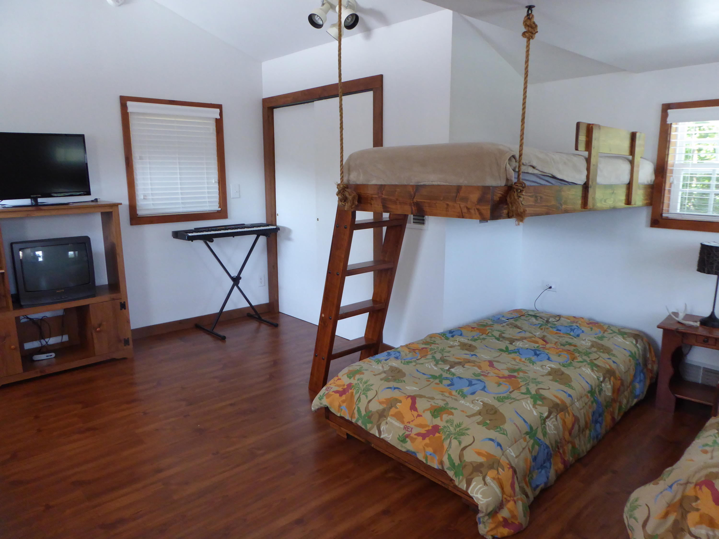 500 Hurds Branch Road Ferrum, VA 24088 - Photo 34 of 60 a bedroom with a bed and a flat tv screen on the dresser