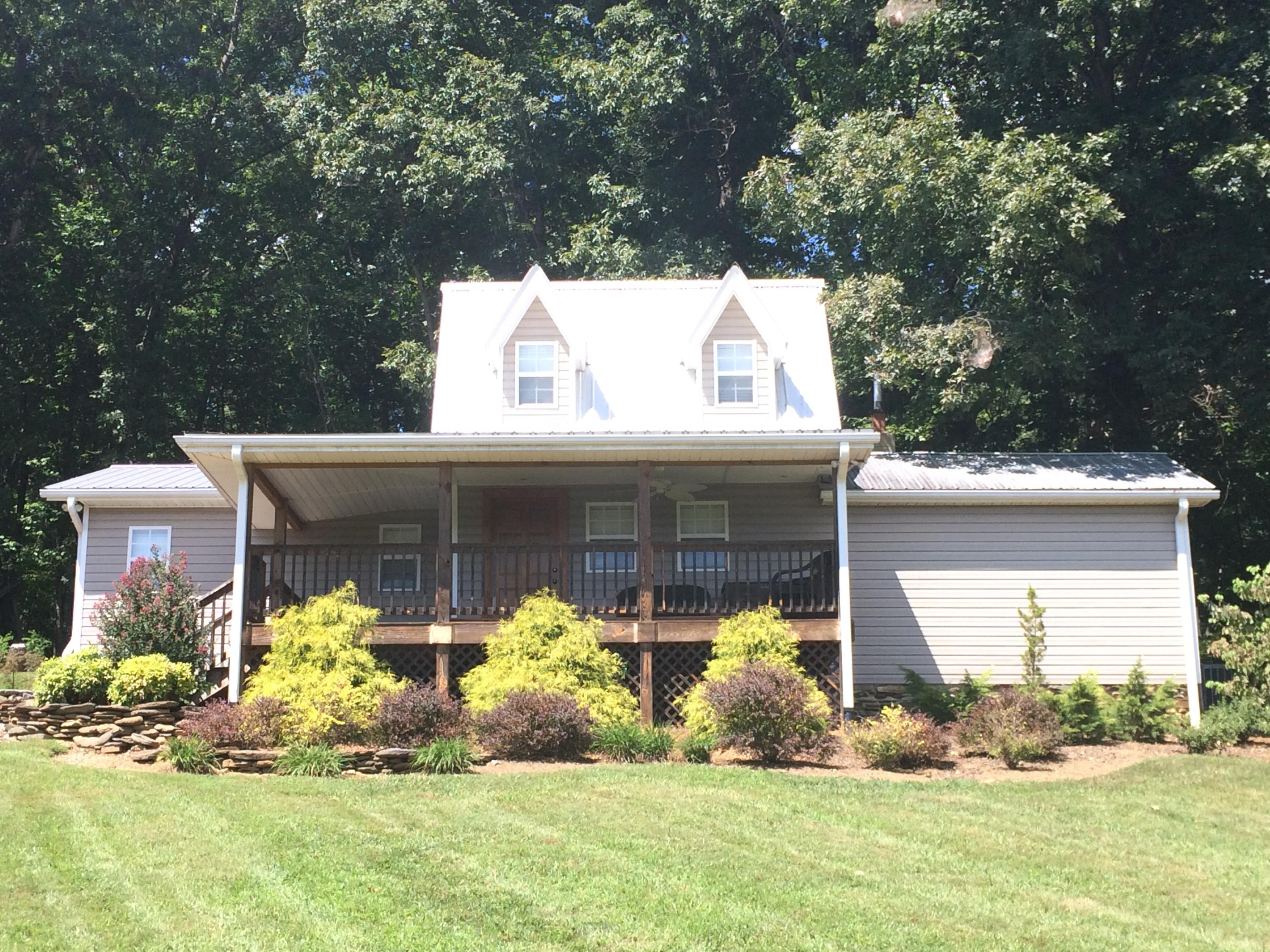 500 Hurds Branch Road Ferrum, VA 24088 - Photo 59 of 60 a front view of a house with a yard and garage