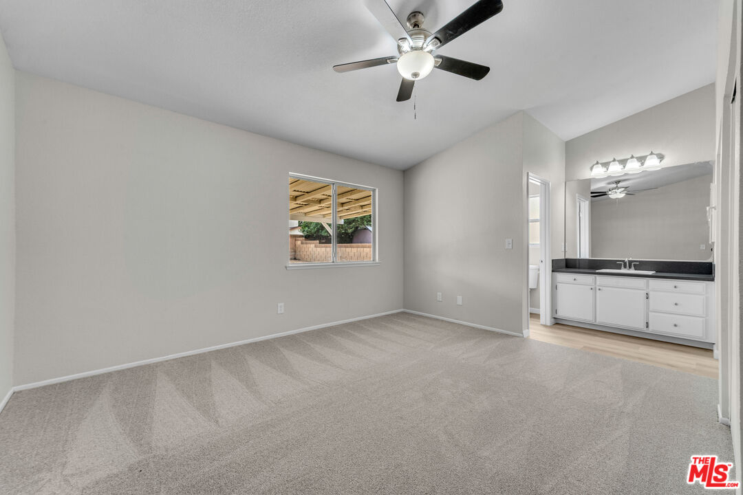 716 East E Avenue Lancaster, CA 93535 - Photo 9 of 17 an empty room with windows and ceiling fan