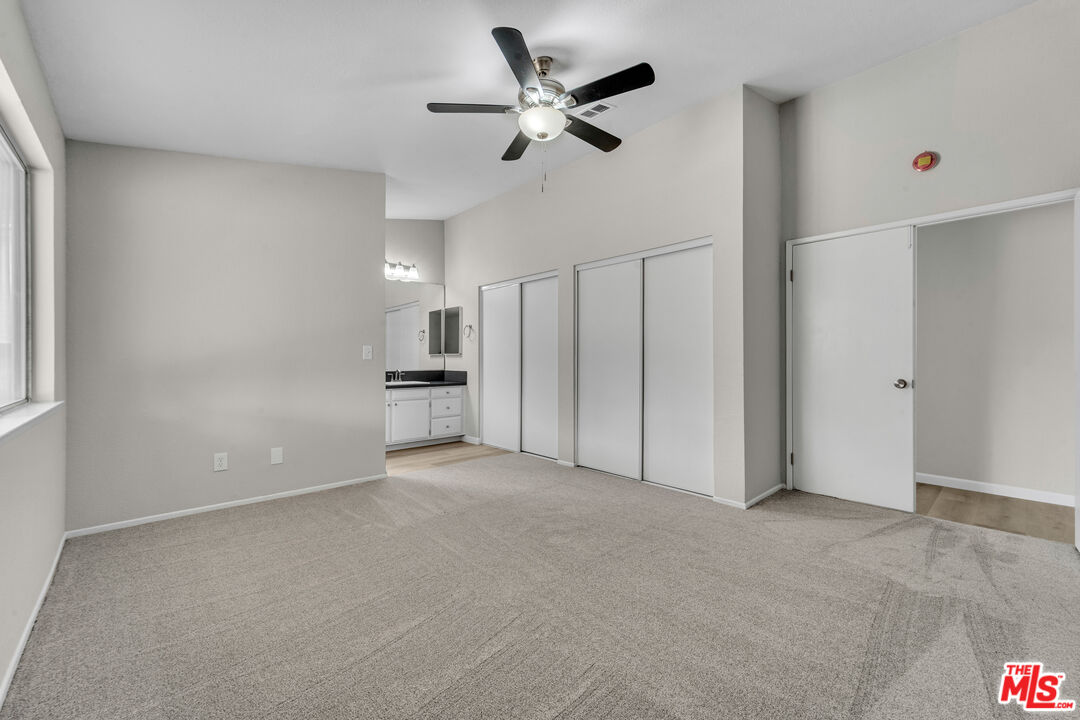 716 East E Avenue Lancaster, CA 93535 - Photo 10 of 17 a view of an empty room and a ceiling fan