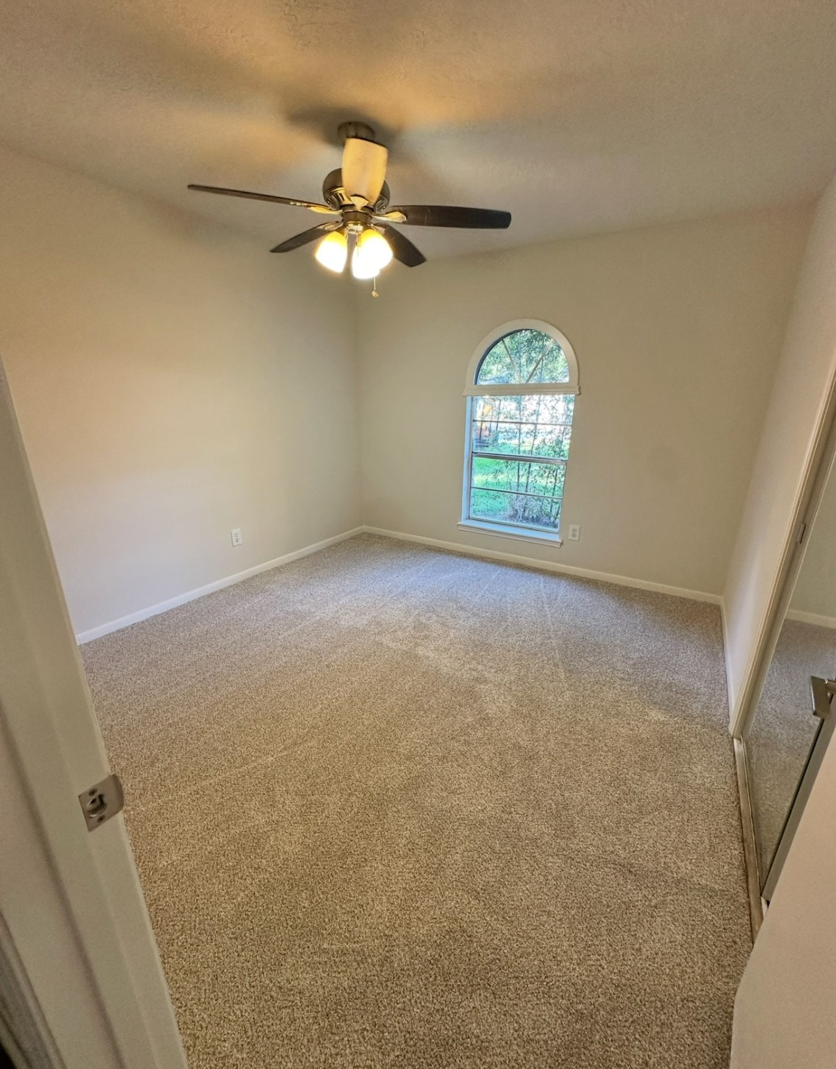 29410 Binefield Street Spring, TX 77386 - Photo 8 of 13 an empty room with windows and chandelier fan