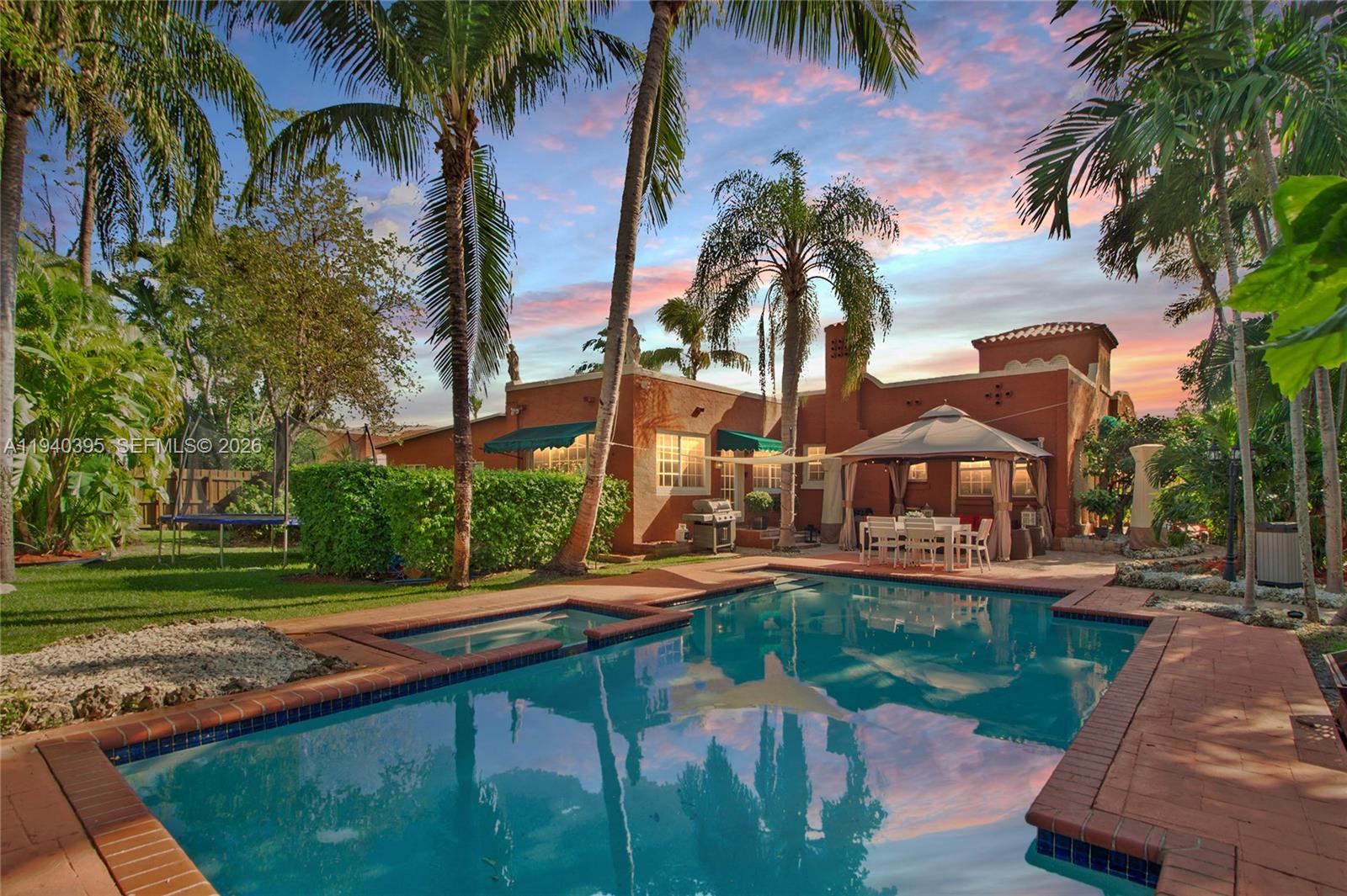 2985 Southwest 13th Street Miami, FL 33145 - Photo 1 of 27 a front view of a house with garden and swimming pool