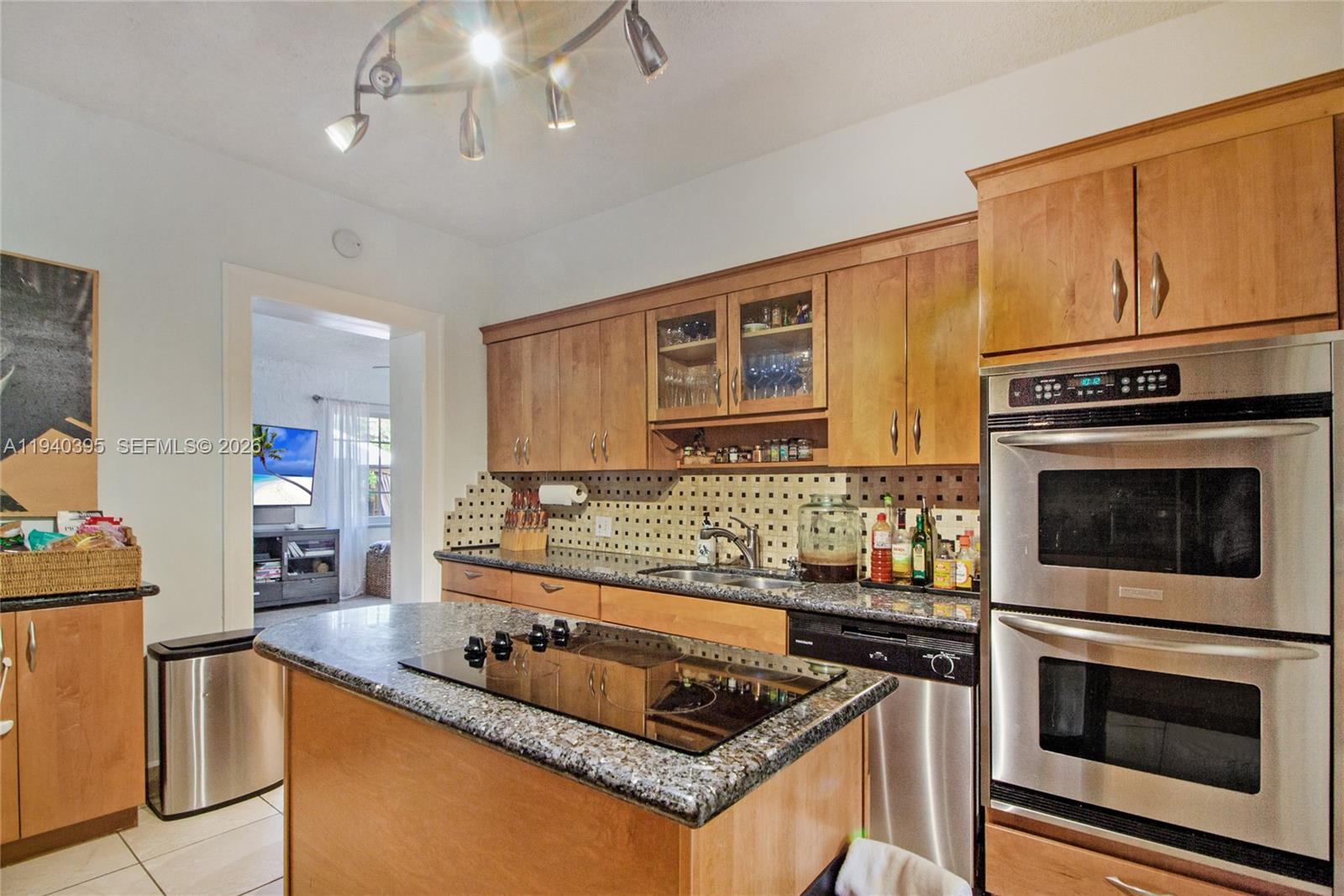 2985 Southwest 13th Street Miami, FL 33145 - Photo 14 of 27 a kitchen with stainless steel appliances granite countertop a stove a sink and a microwave