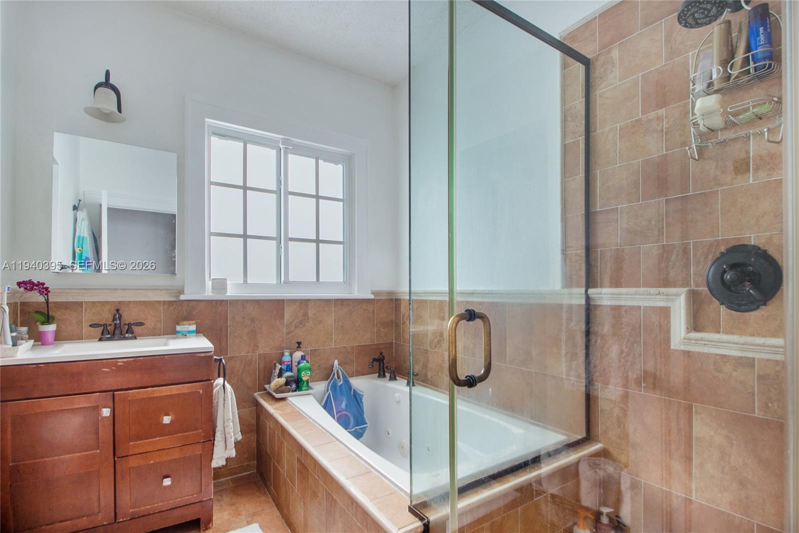 2985 Southwest 13th Street Miami, FL 33145 - Photo 15 of 27 a bathroom with a tub sink and cabinets