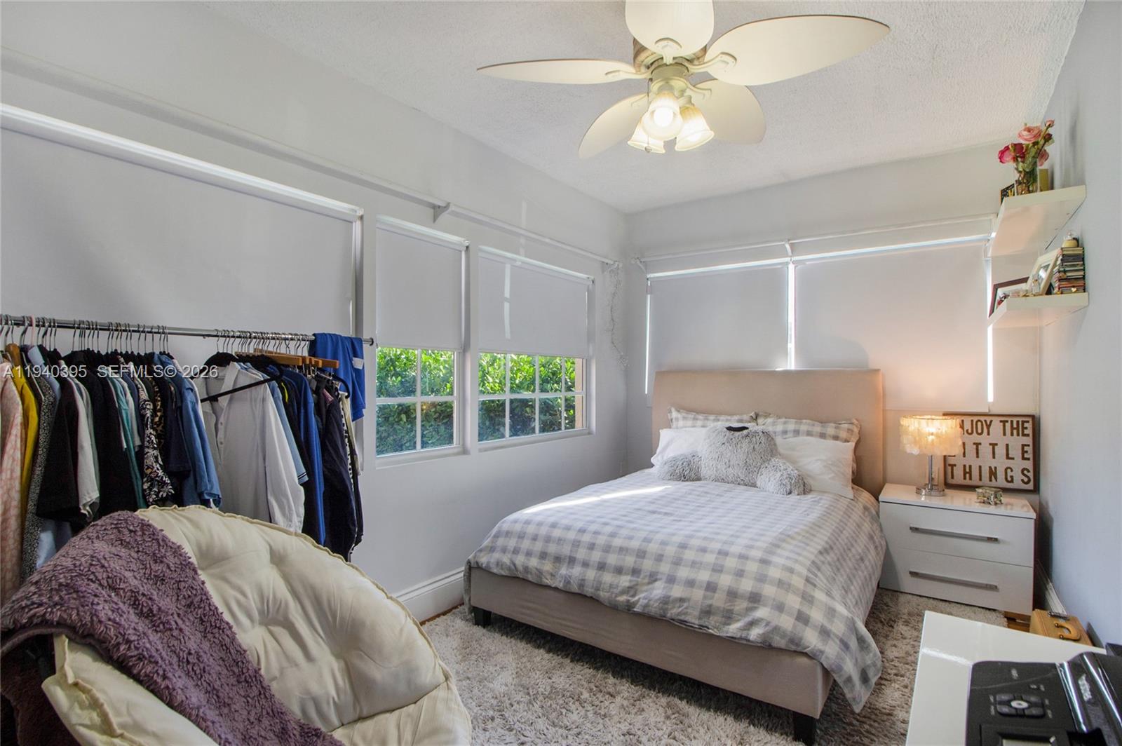 2985 Southwest 13th Street Miami, FL 33145 - Photo 16 of 27 a bedroom with a bed and a chandelier