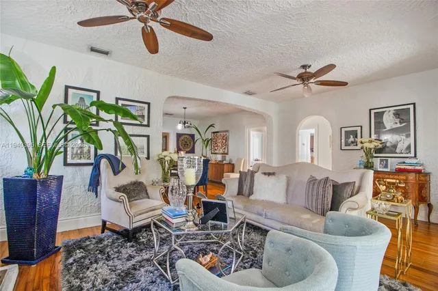 a living room with furniture and a chandelier