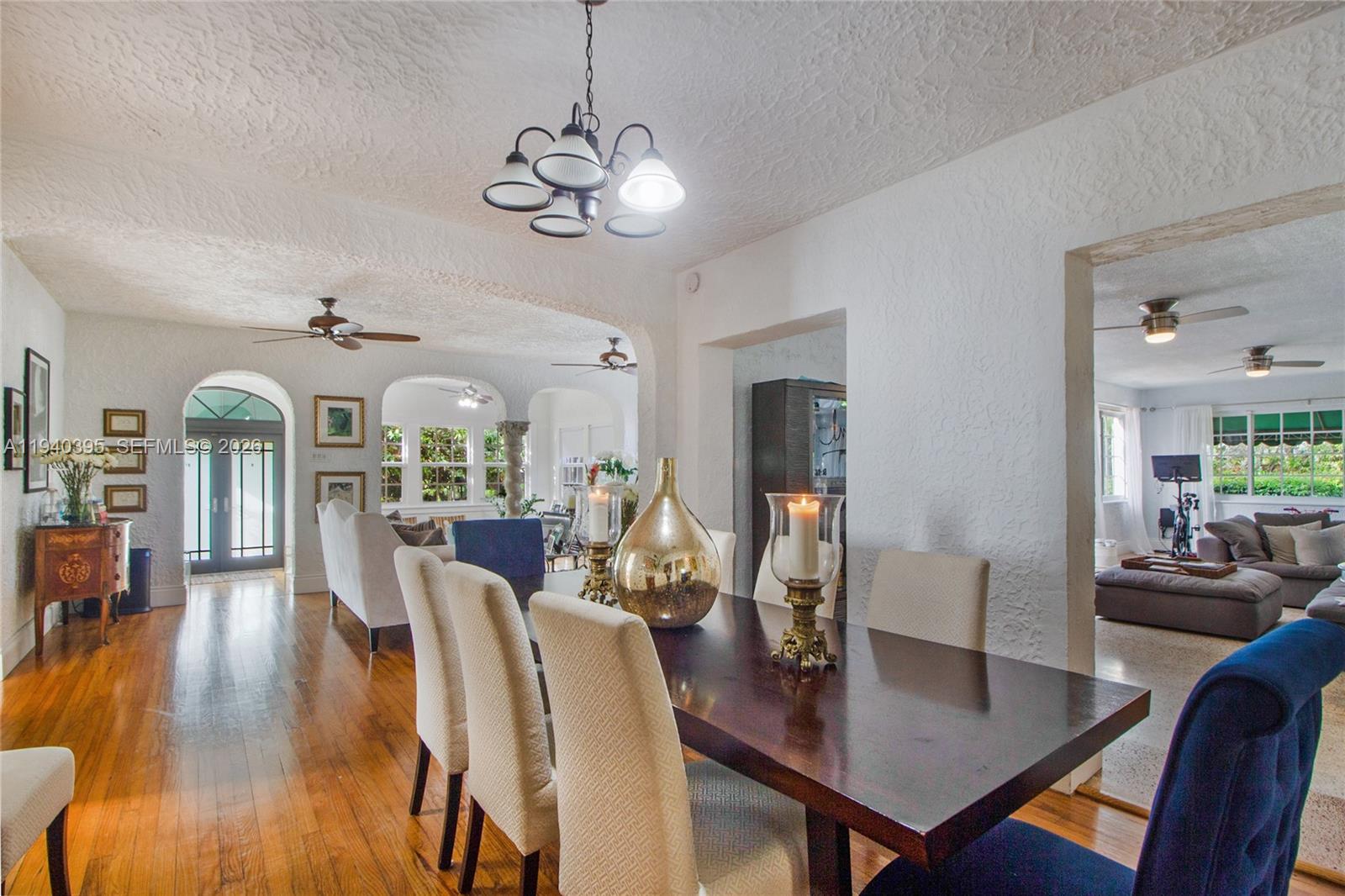 2985 Southwest 13th Street Miami, FL 33145 - Photo 22 of 27 a view of a dining room with furniture a chandelier and wooden floor