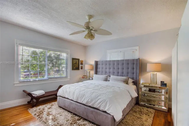 a spacious bedroom with a bed and a chandelier