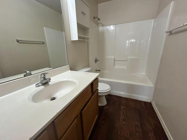 1108 82nd Street, Unit A Lubbock, TX 79423 - Photo 11 of 11 a bathroom with a sink a toilet and a bathtub