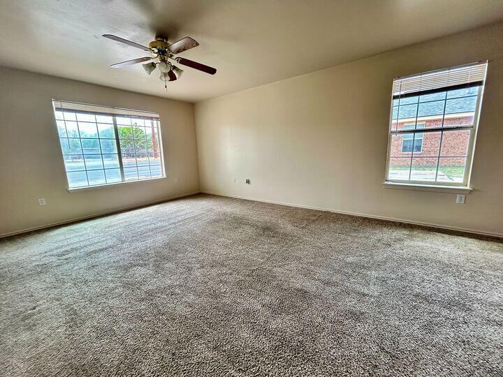 1108 82nd Street, Unit A Lubbock, TX 79423 - Photo 8 of 11 an empty room with a window