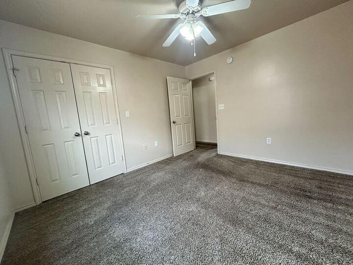 1108 82nd Street, Unit A Lubbock, TX 79423 - Photo 9 of 11 an empty room with fan and entrance