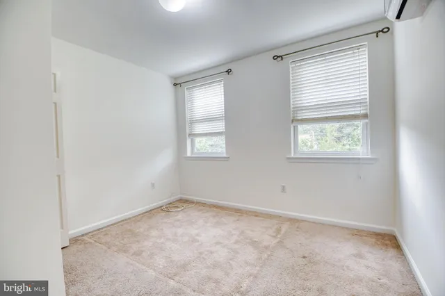 a view of a room with wooden floor and windows