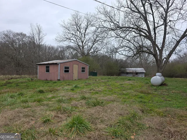 a view of a backyard with large trees
