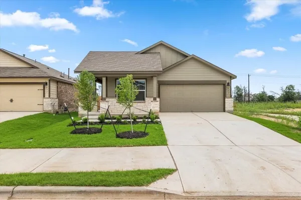 a front view of house with yard and green space