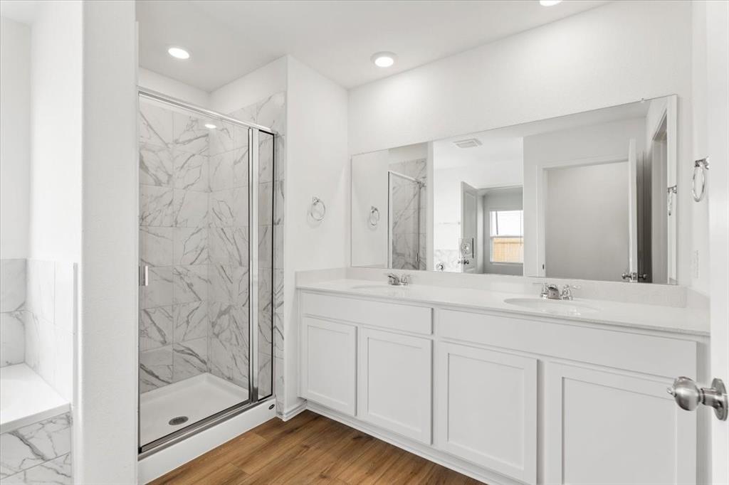 487 Alamito Avenue Kyle, TX 78640 - Photo 25 of 36 a bathroom with a double vanity sink mirror and shower