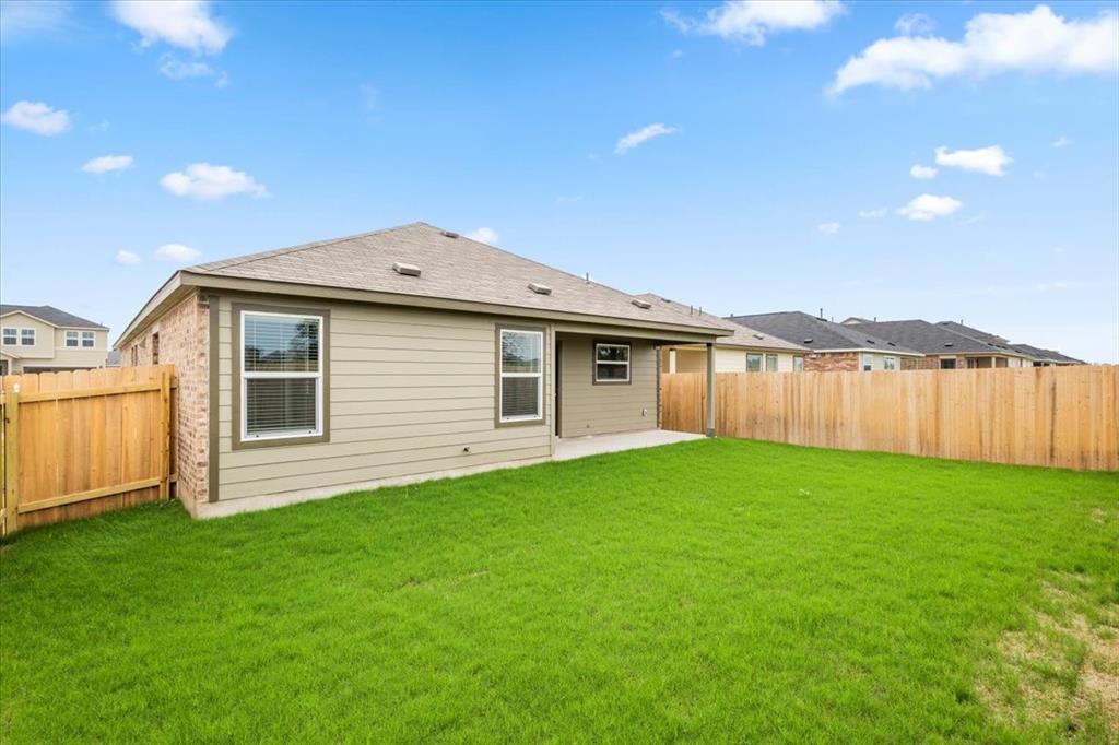 487 Alamito Avenue Kyle, TX 78640 - Photo 31 of 36 a backyard of a house with lots of green space