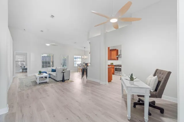 a living room with furniture and wooden floor