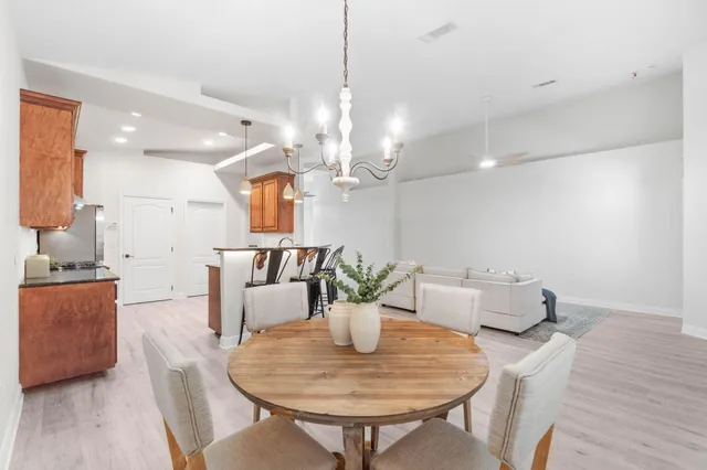 a dining room with furniture and chandelier