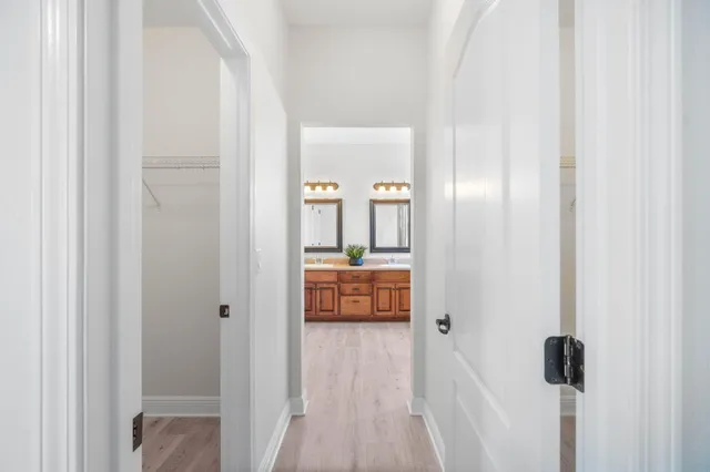 a bathroom with a double vanity sink mirror and shower