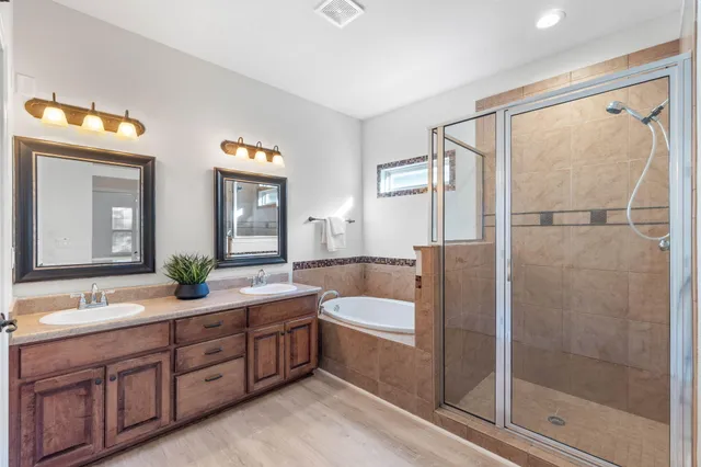a view of a hallway with wooden floor and closet area