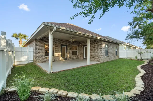 a backyard of a house with table and chairs