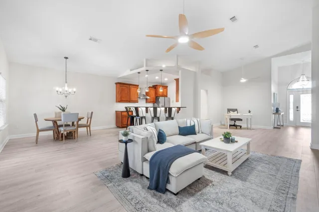 a living room with furniture and a chandelier